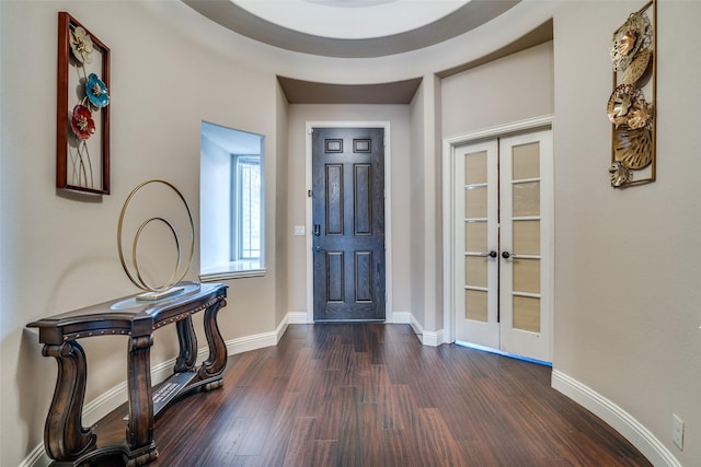 foyer entrance with dark wood-type flooring and french doors