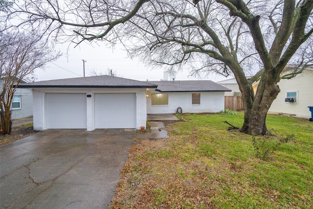 ranch-style house with a garage and a front yard