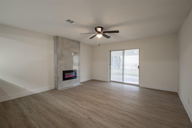 unfurnished living room featuring ceiling fan, a fireplace, and hardwood / wood-style floors