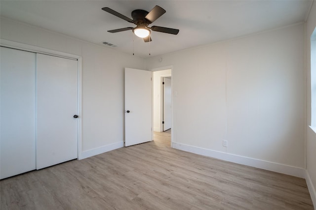 unfurnished bedroom with ceiling fan, a closet, and light hardwood / wood-style flooring