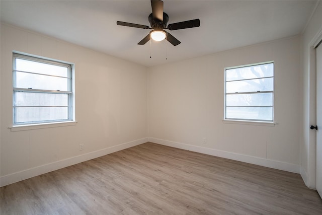 unfurnished room featuring a wealth of natural light, ceiling fan, and light wood-type flooring