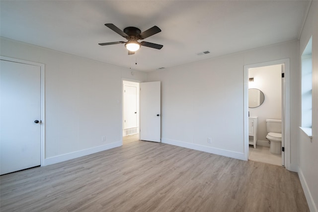 unfurnished bedroom featuring ceiling fan, connected bathroom, and light wood-type flooring