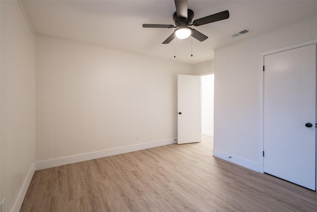 unfurnished room featuring ornamental molding, ceiling fan, and light wood-type flooring