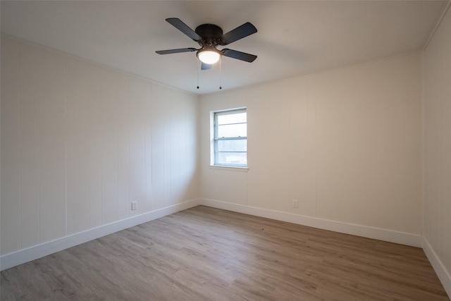 spare room featuring hardwood / wood-style floors, crown molding, and ceiling fan