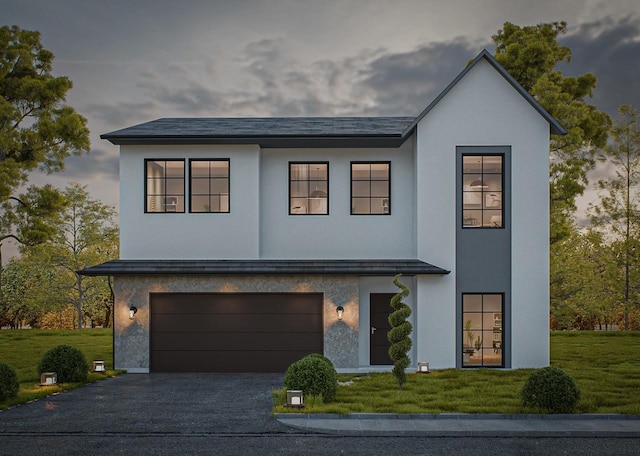 view of front of house featuring a garage and a yard