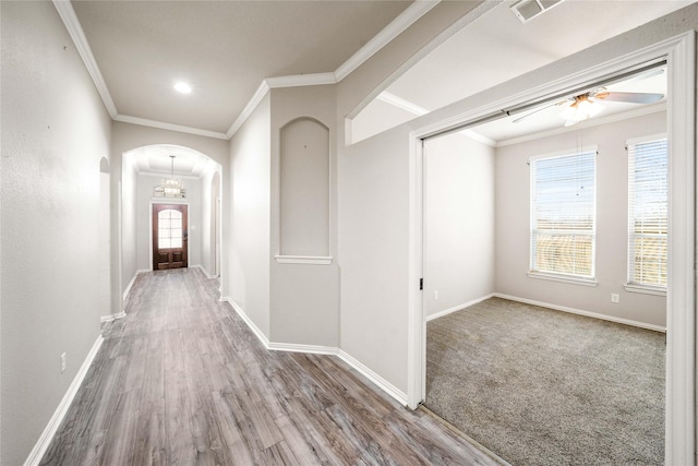 hall with hardwood / wood-style flooring and ornamental molding