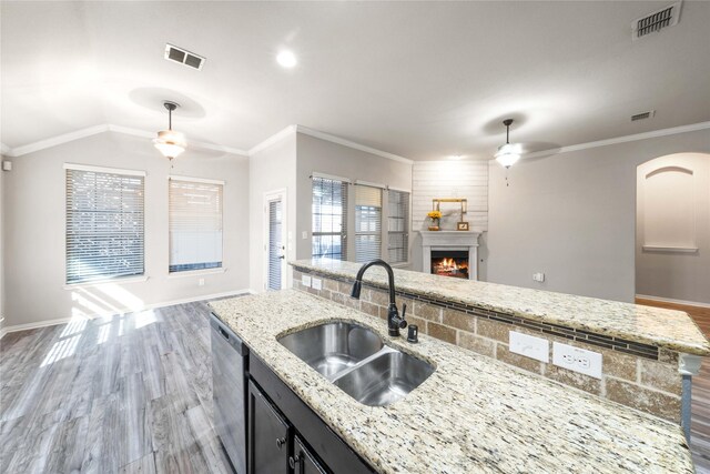 kitchen featuring light stone counters, sink, stainless steel dishwasher, and ceiling fan