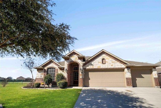 view of front of house featuring a garage and a front lawn