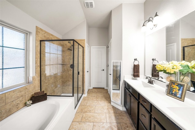 bathroom featuring lofted ceiling, vanity, separate shower and tub, and tile patterned flooring