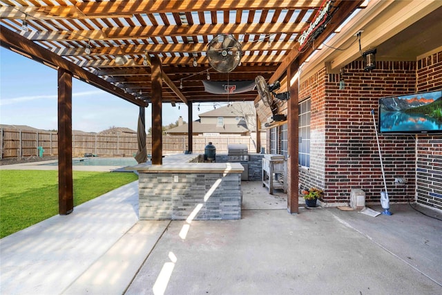 view of patio / terrace with area for grilling, a pergola, and exterior kitchen