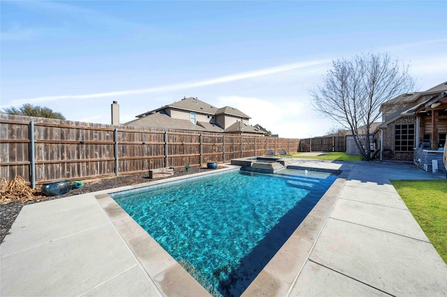 view of swimming pool featuring a patio area and an in ground hot tub