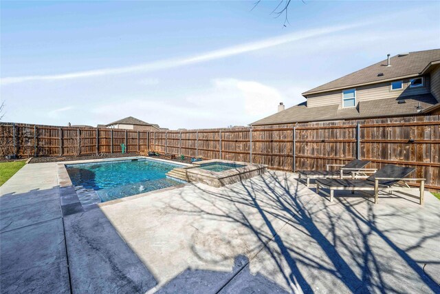 view of pool with a patio area and an in ground hot tub