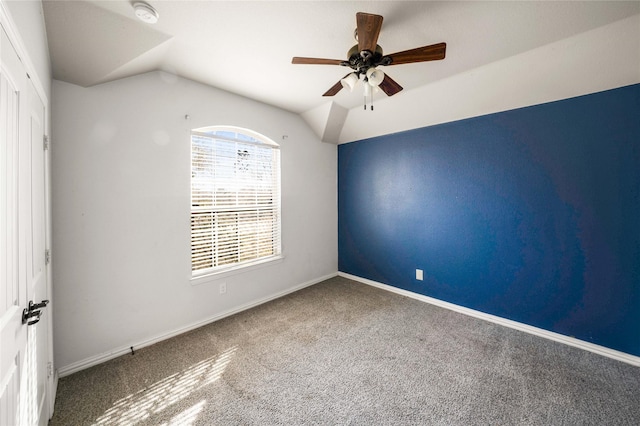 carpeted spare room with lofted ceiling and ceiling fan