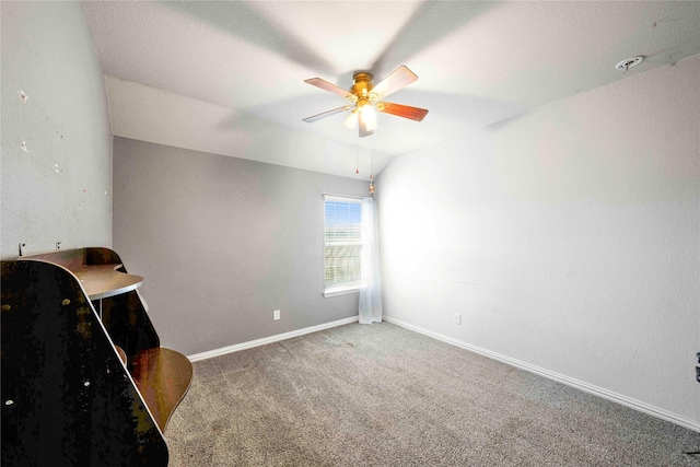 interior space featuring vaulted ceiling, ceiling fan, and carpet floors