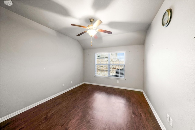 spare room with lofted ceiling, dark hardwood / wood-style floors, and ceiling fan