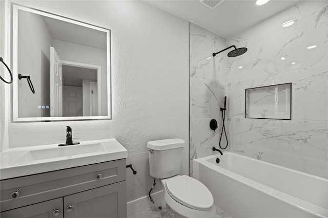 full bathroom featuring tiled shower / bath, vanity, and toilet