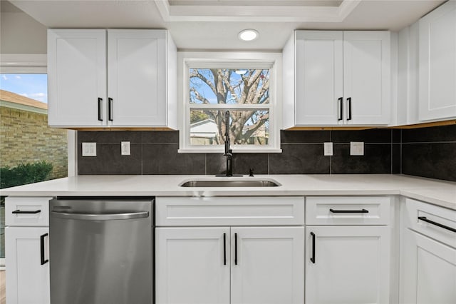 kitchen with white cabinetry, tasteful backsplash, and dishwasher