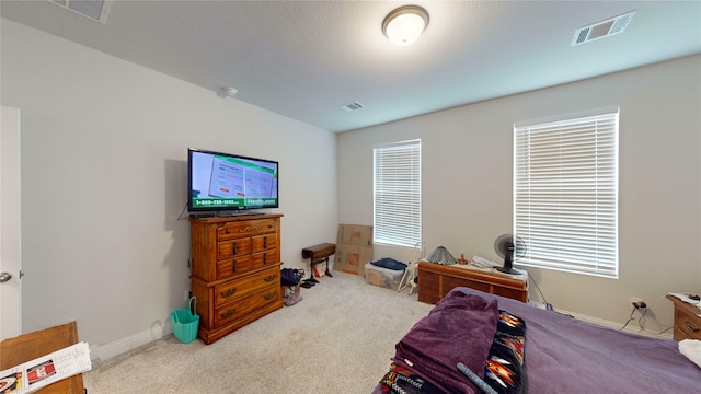 bedroom featuring light colored carpet