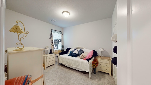 carpeted bedroom with a textured ceiling