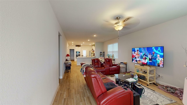 living room featuring ceiling fan and light hardwood / wood-style floors