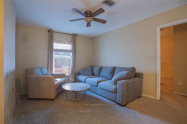 living room with carpet floors, a textured ceiling, and ceiling fan