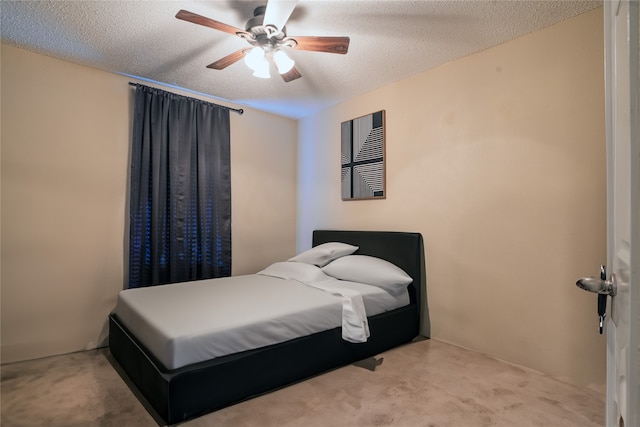 bedroom featuring ceiling fan, light colored carpet, and a textured ceiling