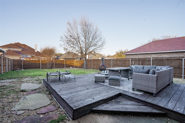 wooden deck with an outdoor living space and a yard