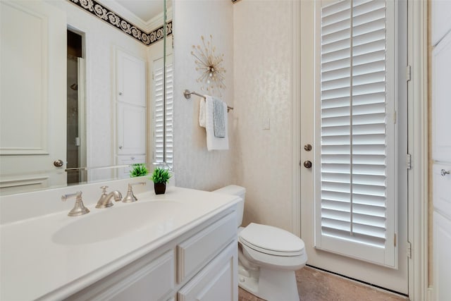 bathroom featuring ornamental molding, vanity, and toilet