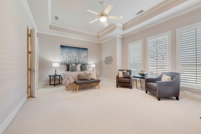 bedroom with a raised ceiling, ornamental molding, carpet, and ceiling fan