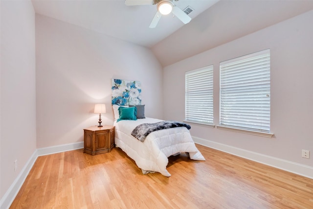 bedroom with ceiling fan, lofted ceiling, and light hardwood / wood-style floors