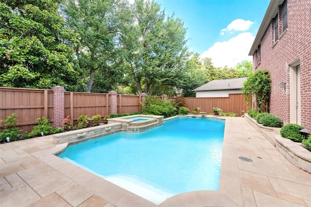 view of pool featuring a patio area and an in ground hot tub