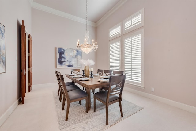 carpeted dining room with ornamental molding, a chandelier, a healthy amount of sunlight, and a high ceiling