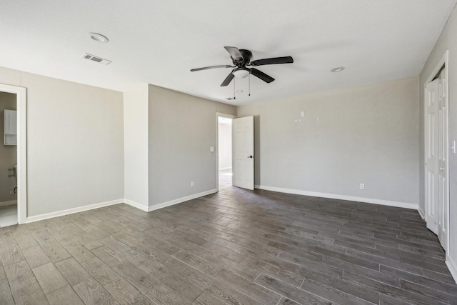 unfurnished room with dark hardwood / wood-style flooring and ceiling fan