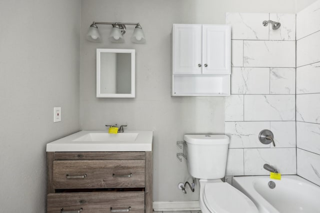 full bathroom featuring vanity, tiled shower / bath, and toilet