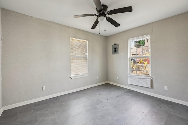 empty room with electric panel and ceiling fan