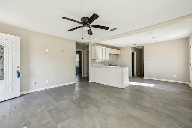 unfurnished living room with ceiling fan