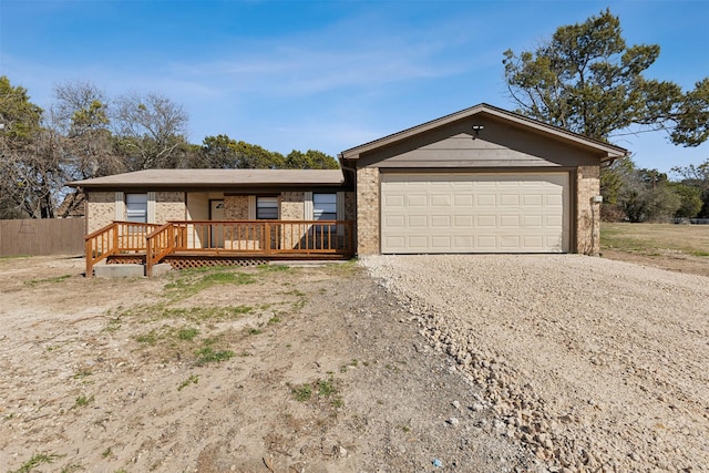 ranch-style home with a garage and a deck