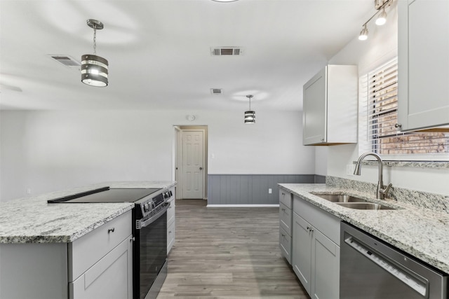 kitchen featuring sink, gray cabinets, dishwasher, light stone counters, and stainless steel electric range oven