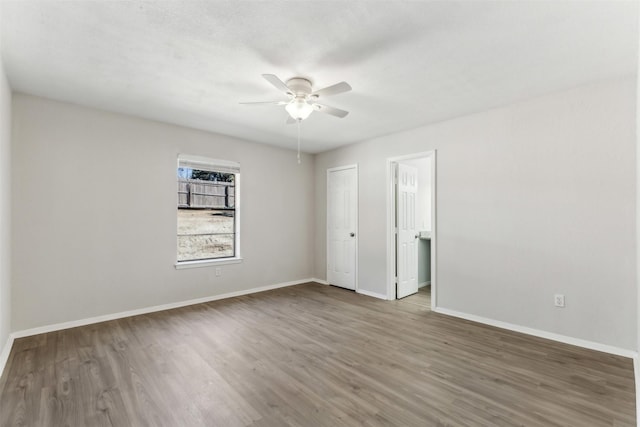 spare room featuring hardwood / wood-style floors and ceiling fan