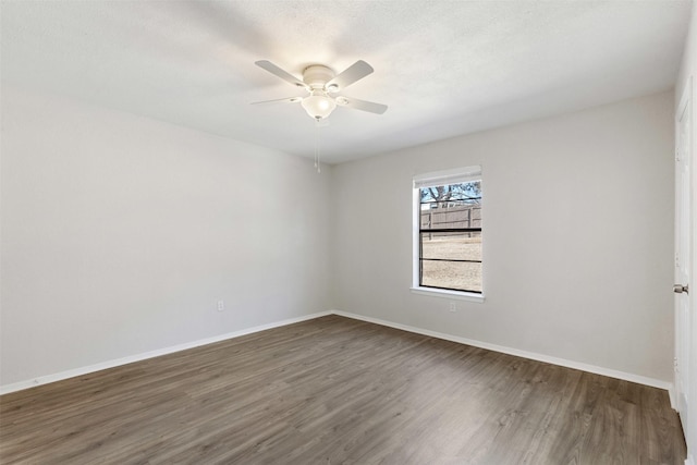 unfurnished room featuring a textured ceiling, dark hardwood / wood-style floors, and ceiling fan