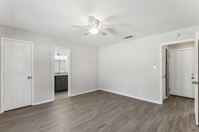 interior space with ceiling fan and dark hardwood / wood-style floors