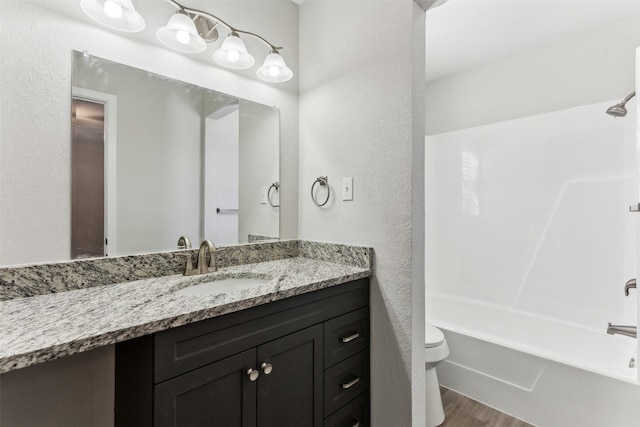 full bathroom featuring vanity, tub / shower combination, hardwood / wood-style floors, and toilet