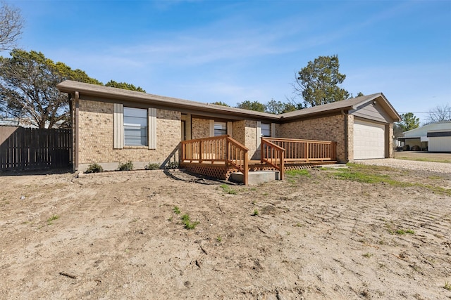 ranch-style home with a garage and a deck