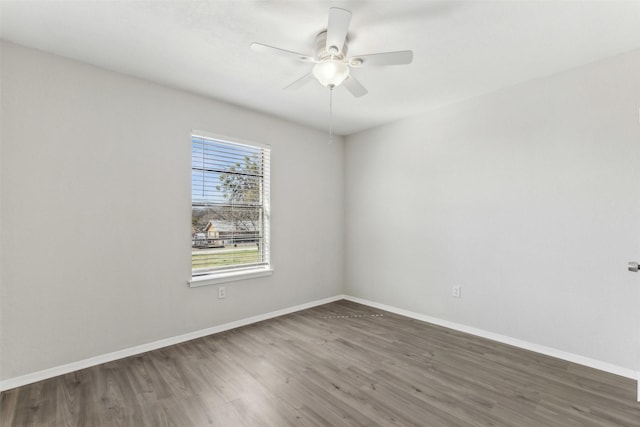 spare room with ceiling fan and dark hardwood / wood-style flooring