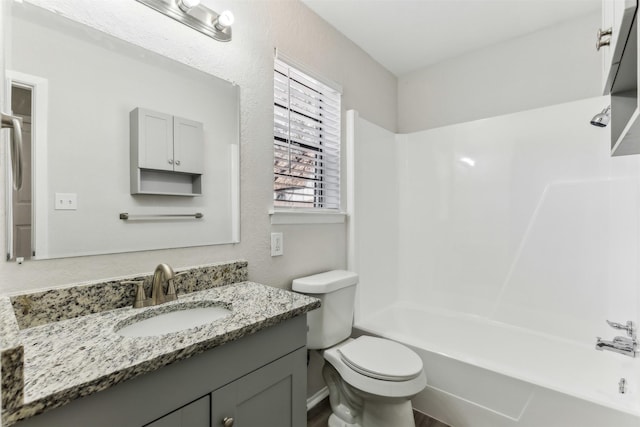 full bathroom with vanity, toilet, and  shower combination