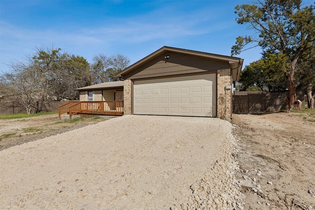 view of front of property featuring a wooden deck and a garage