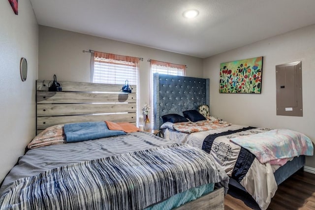 bedroom with hardwood / wood-style flooring and electric panel