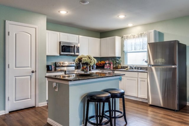 kitchen featuring sink, a center island, white cabinets, and appliances with stainless steel finishes