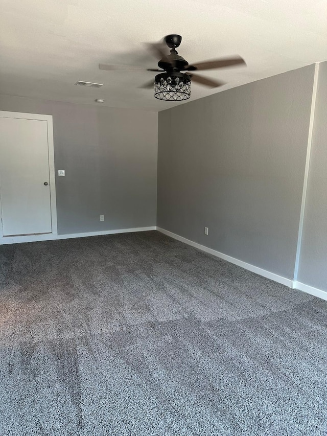 carpeted empty room featuring ceiling fan