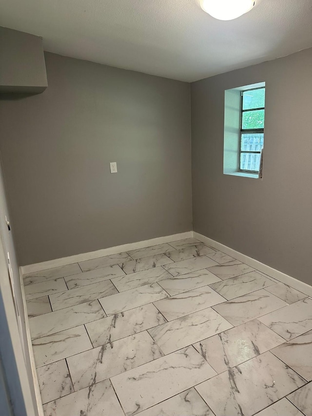 empty room featuring a textured ceiling